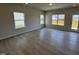 Bright living area showcasing wood-look floors, natural light from surrounding windows, and access to the backyard at 76 Commons Cir, Clayton, NC 27520