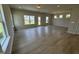 Spacious and bright living room featuring wood-look floors and large windows offering ample natural light at 76 Commons Cir, Clayton, NC 27520