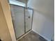 Modern shower with glass enclosure and grey flooring at 76 Commons Cir, Clayton, NC 27520