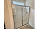 Modern shower with glass doors and built-in shelving for convenience at 76 Commons Cir, Clayton, NC 27520