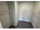 A walk-in closet features carpeted floors and includes shelving around the perimeter at 76 Commons Cir, Clayton, NC 27520