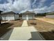 Backyard with cement patio and walkway leading to two single car garages at 765 Portland Rose Dr, Knightdale, NC 27545