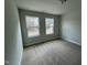 This bedroom features neutral carpet, paint, and large windows for plenty of natural light at 765 Portland Rose Dr, Knightdale, NC 27545