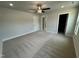 Large bedroom with neutral carpet, paint, ceiling fan, and access to en suite bathroom at 765 Portland Rose Dr, Knightdale, NC 27545