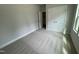 Cozy bedroom with neutral carpet, a large window, and a closet with double doors at 765 Portland Rose Dr, Knightdale, NC 27545