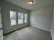 Bright bedroom featuring plush carpet and three large windows that bring in natural light at 765 Portland Rose Dr, Knightdale, NC 27545
