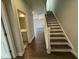 Inviting entryway with hardwood floors, staircase, and views into the open-concept living spaces at 765 Portland Rose Dr, Knightdale, NC 27545