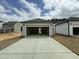 Outside view of the garage with an opened door and a cement driveway at 765 Portland Rose Dr, Knightdale, NC 27545