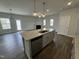 Open concept kitchen with large island, granite countertops, and stainless steel appliances at 765 Portland Rose Dr, Knightdale, NC 27545