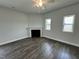 Living room area with wood floors, a fireplace, and bright windows at 765 Portland Rose Dr, Knightdale, NC 27545