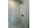 Modern shower featuring elegant marble-style tiling and brushed nickel fixtures for a luxurious bathing experience at 765 Portland Rose Dr, Knightdale, NC 27545