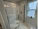 Bathroom features a large shower with seamless glass door and neutral tile at 765 Portland Rose Dr, Knightdale, NC 27545