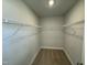 Spacious walk-in closet with neutral carpet, paint, and shelving for storage at 765 Portland Rose Dr, Knightdale, NC 27545