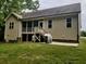 Exterior view of a house featuring a screened porch, patio, and well-maintained lawn at 79 Hillgrove Dr, Willow Springs, NC 27592
