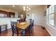 Dining room area with dark wood floors and view into kitchen at 79 Hillgrove Dr, Willow Springs, NC 27592