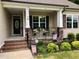 Inviting front porch with stone accents, decorative railings, and charming curb appeal at 79 Hillgrove Dr, Willow Springs, NC 27592