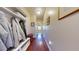 Well-lit hallway with storage, coat rack and hardwood floors that connects various rooms in the home at 79 Hillgrove Dr, Willow Springs, NC 27592
