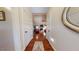 Hallway featuring wood floors that leads to a living area and is illuminated by natural light at 79 Hillgrove Dr, Willow Springs, NC 27592