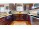 Kitchen features granite counters, tile backsplash, stainless steel appliances and wood floors at 79 Hillgrove Dr, Willow Springs, NC 27592