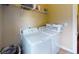 Practical laundry area equipped with a washer, dryer, shelving, and ample storage space at 79 Hillgrove Dr, Willow Springs, NC 27592