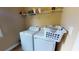 Functional laundry space featuring a washer and dryer, with convenient shelving for storage at 79 Hillgrove Dr, Willow Springs, NC 27592