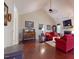 Open living room featuring a fireplace, hardwood floors, and comfortable red seating at 79 Hillgrove Dr, Willow Springs, NC 27592