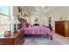 Main bedroom with tray ceiling and large windows providing natural light at 79 Hillgrove Dr, Willow Springs, NC 27592