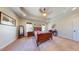 Main bedroom featuring tray ceiling and large windows providing natural light at 79 Hillgrove Dr, Willow Springs, NC 27592