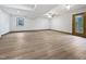 Large basement area with light wood flooring and a window at 8125 Park Side Dr, Raleigh, NC 27612