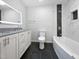Modern bathroom featuring tiled walls, granite counters, and standalone tub at 8125 Park Side Dr, Raleigh, NC 27612