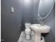 Contemporary half-bath featuring gray walls, pedestal sink, and patterned tile floor at 8125 Park Side Dr, Raleigh, NC 27612
