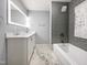 Modern bathroom featuring double sink vanity and a large soaking tub with tiled shower at 8125 Park Side Dr, Raleigh, NC 27612
