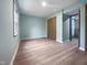 Bedroom with a closet, wood floor, and a blue wall at 8125 Park Side Dr, Raleigh, NC 27612