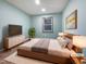 Cozy bedroom featuring neutral walls, light-colored floor, and a large window at 8125 Park Side Dr, Raleigh, NC 27612