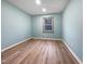 Bright bedroom with light colored walls and flooring with a window at 8125 Park Side Dr, Raleigh, NC 27612