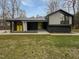 Modern black house with metal roof and yellow front doors and window frames at 8125 Park Side Dr, Raleigh, NC 27612