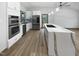 Modern kitchen with stainless steel appliances and a large waterfall island at 8125 Park Side Dr, Raleigh, NC 27612