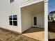 The back patio features a concrete floor and a single glass door to the house at 84 Commons Cir, Clayton, NC 27520