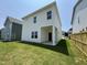 Spacious backyard with lush green grass and a view of the home's exterior at 84 Commons Cir, Clayton, NC 27520