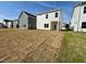 A wide shot shows the back of the home with a newly seeded lawn and other homes in the community at 84 Commons Cir, Clayton, NC 27520