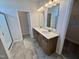 Bathroom featuring double sinks, modern fixtures, and a tile floor at 84 Commons Cir, Clayton, NC 27520