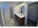 Bathroom with dual sinks, tile floors, and walk-in closet at 84 Commons Cir, Clayton, NC 27520