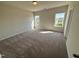 Bedroom with plush carpeting and natural light from the two windows at 84 Commons Cir, Clayton, NC 27520
