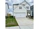 Charming two-story home featuring a spacious two-car garage and manicured lawn at 84 Commons Cir, Clayton, NC 27520