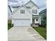 Charming two-story home featuring a spacious two-car garage and manicured lawn at 84 Commons Cir, Clayton, NC 27520