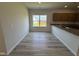 Cozy dining area next to the kitchen featuring wood grain flooring and a view of the backyard at 84 Commons Cir, Clayton, NC 27520