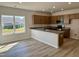 Well-lit kitchen offers granite countertops, stainless appliances, and a view to the backyard at 84 Commons Cir, Clayton, NC 27520