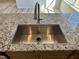 Close-up of a stainless steel kitchen sink set in a granite countertop at 84 Commons Cir, Clayton, NC 27520