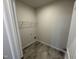 Laundry room with tile floor, utility hookups, and a wire shelf at 84 Commons Cir, Clayton, NC 27520