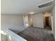 Upstairs loft area featuring neutral carpeting and access to multiple rooms at 84 Commons Cir, Clayton, NC 27520